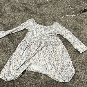 White dress with blue, pink, and yellow flowers on it